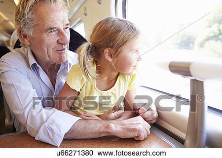 Grandfather And Granddaughter Relaxing On Train Journey View Large Photo Image Stock Image - Grandfather And Granddaughter Relaxing On Train Journey. Fotosearch