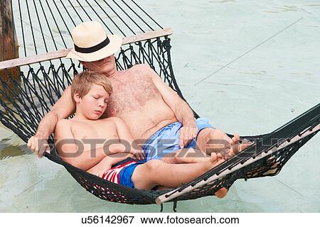 Grandfather And Grandson Relaxing In Beach Hammock View Large Photo Image Stock Photo - Grandfather And Grandson Relaxing In Beach Hammock . Fotosearch
