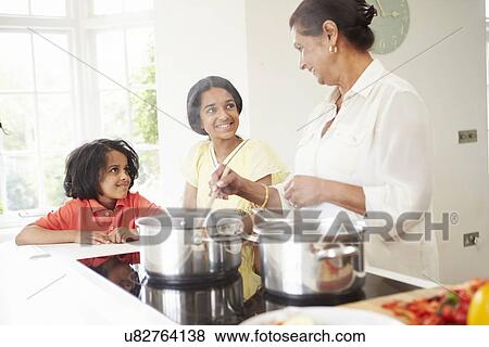 Stock Photo - Grandmother And Grandchildren Cooking Meal At Home. Fotosearch