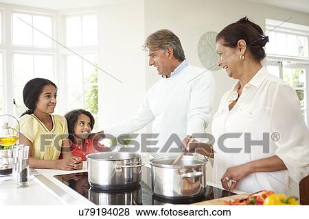 Grandparents And Grandchildren Cooking Meal At Home View Large Photo Image Stock Photo - Grandparents And Grandchildren Cooking Meal At Home. Fotosearch