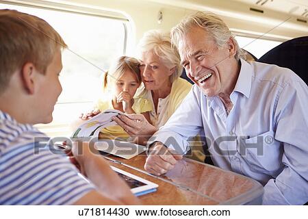 Grandparents And Grandchildren Relaxing On Train Journey View Large Photo Image Stock Image - Grandparents And Grandchildren Relaxing On Train Journey. Fotosearch