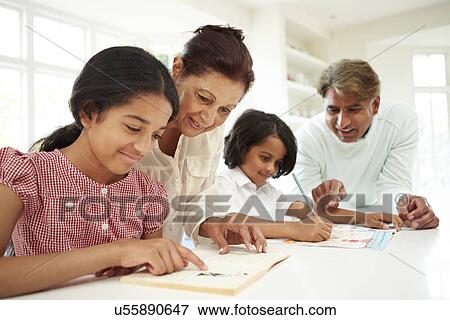Stock Photo - Grandparents Helping Children With Homework. Fotosearch