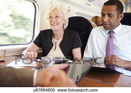Group Of Businesspeople Having Meeting On Train View Large Photo Image Stock Photography - Group Of Businesspeople Having Meeting On Train. Fotosearch
