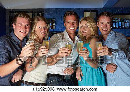 Group Of Friends Enjoying Glass Of Champagne In Bar View Large Photo Image Stock Photo - Group Of Friends Enjoying Glass Of Champagne In Bar. Fotosearch