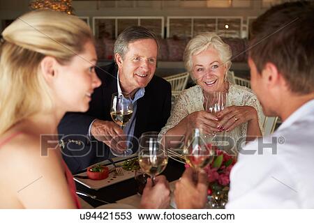 Group Of Friends Enjoying Meal In Restaurant View Large Photo Image Stock Image - Group Of Friends Enjoying Meal In Restaurant. Fotosearch