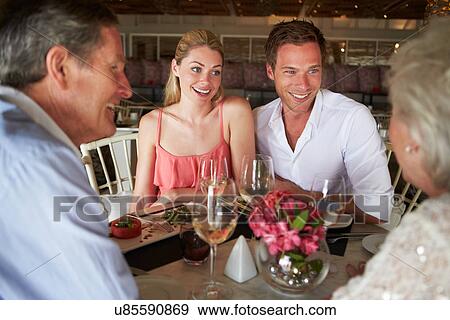 Group Of Friends Enjoying Meal In Restaurant View Large Photo Image Stock Photo - Group Of Friends Enjoying Meal In Restaurant. Fotosearch