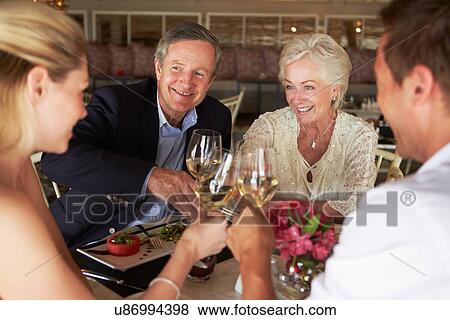 Group Of Friends Enjoying Meal In Restaurant View Large Photo Image Stock Photo - Group Of Friends Enjoying Meal In Restaurant. Fotosearch