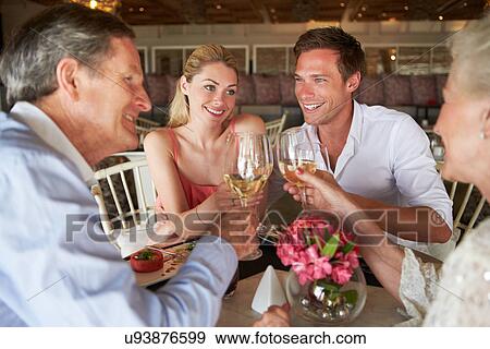Group Of Friends Enjoying Meal In Restaurant View Large Photo Image Stock Photo - Group Of Friends Enjoying Meal In Restaurant. Fotosearch