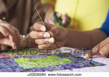 Picture - Group Of Women Making Quilt Together. Fotosearch