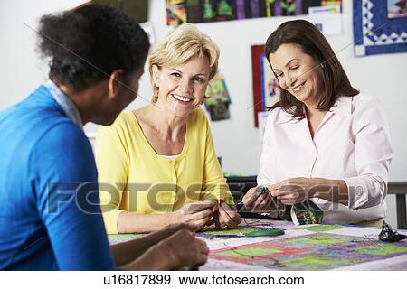 Stock Photo - Group Of Women Making Quilt Together. Fotosearch