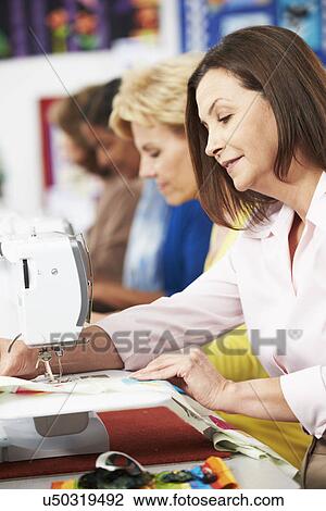 Group Of Women Using Electric Sewing Machines In class View Large Photo Image Stock Image - Group Of Women Using Electric Sewing Machines In class. Fotosearch