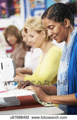 Group Of Women Using Electric Sewing Machines In class View Large Photo Image Stock Image - Group Of Women Using Electric Sewing Machines In class. Fotosearch