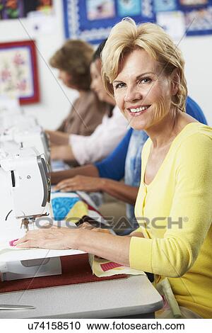 Group Of Women Using Electric Sewing Machines In class View Large Photo Image Stock Image - Group Of Women Using Electric Sewing Machines In class. Fotosearch