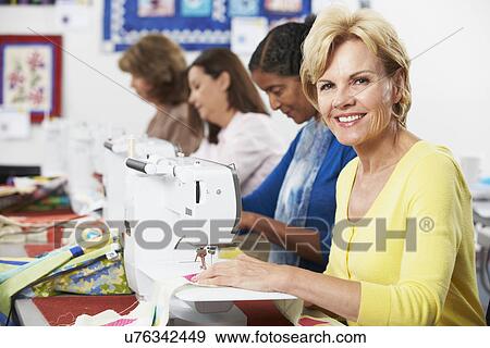 Group Of Women Using Electric Sewing Machines In class View Large Photo Image Stock Photo - Group Of Women Using Electric Sewing Machines In class. Fotosearch