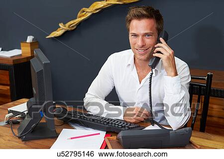 Hotel Receptionist Using Computer And Phone View Large Photo Image Stock Photograph - Hotel Receptionist Using Computer And Phone. Fotosearch