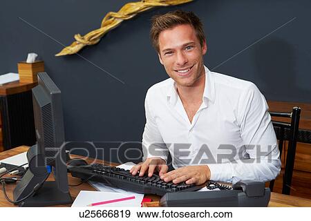 Stock Photo - Hotel Receptionist Working At Computer. Fotosearch