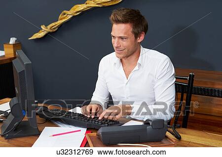 Hotel Receptionist Working At Computer View Large Photo Image Stock Photo - Hotel Receptionist Working At Computer. Fotosearch