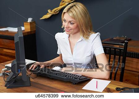 Stock Photo - Hotel Receptionist Working At Computer. Fotosearch