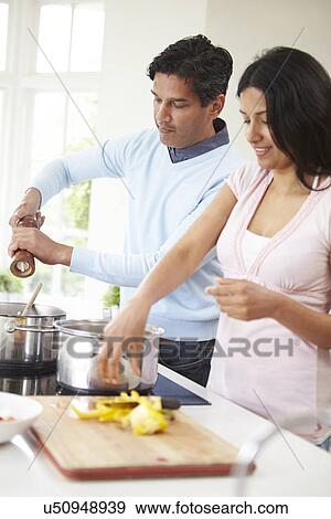 Indian Couple Cooking Meal At Home View Large Photo Image Stock Photo - Indian Couple Cooking Meal At Home. Fotosearch