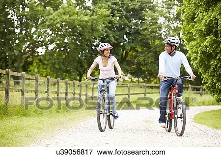 Indian Couple On Cycle Ride In Countryside View Large Photo Image Stock Photo - Indian Couple On Cycle Ride In Countryside. Fotosearch