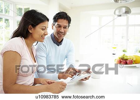 Indian Couple Using Digital Tablet At Home View Large Photo Image Stock Photography - Indian Couple Using Digital Tablet At Home. Fotosearch