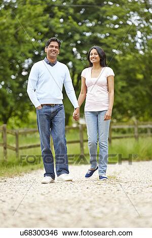Stock Photograph - Indian Couple Walking In Countryside. Fotosearch