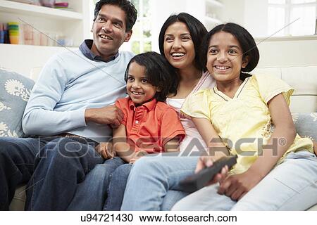 Indian Family Sitting On Sofa Watching TV Together View Large Photo Image Stock Image - Indian Family Sitting On Sofa Watching TV Together. Fotosearch
