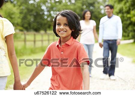 Stock Image - Indian Family Walking In Countryside. Fotosearch