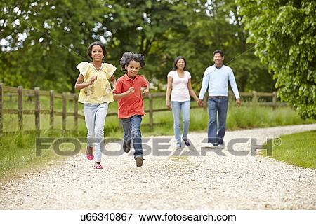 Stock Photo - Indian Family Walking In Countryside. Fotosearch