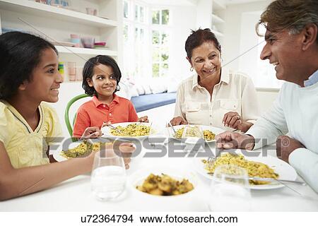 Picture - Indian Grandparents And Grandchildren Eating Meal At Home. Fotosearch