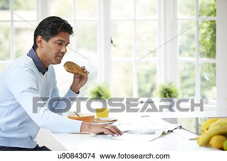 Indian Man Enjoying Breakfast At Home View Large Photo Image Picture - Indian Man Enjoying Breakfast At Home. Fotosearch