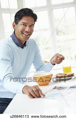 Indian Man Enjoying Breakfast At Home View Large Photo Image Stock Image - Indian Man Enjoying Breakfast At Home. Fotosearch