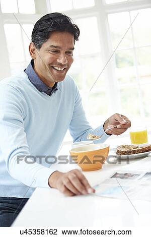 Indian Man Enjoying Breakfast At Home View Large Photo Image Stock Image - Indian Man Enjoying Breakfast At Home. Fotosearch