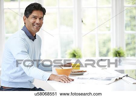 Indian Man Enjoying Breakfast At Home View Large Photo Image Stock Image - Indian Man Enjoying Breakfast At Home. Fotosearch