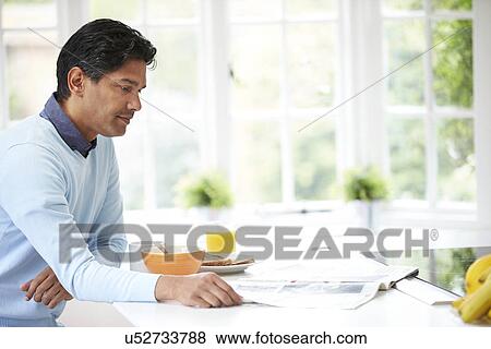 Stock Photo - Indian Man Enjoying Breakfast At Home. Fotosearch