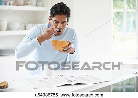 Stock Photography - Indian Man Enjoying Breakfast At Home. Fotosearch