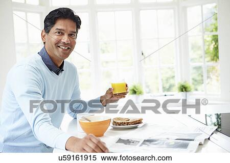 Indian Man Enjoying Breakfast At Home View Large Photo Image Stock Photography - Indian Man Enjoying Breakfast At Home. Fotosearch
