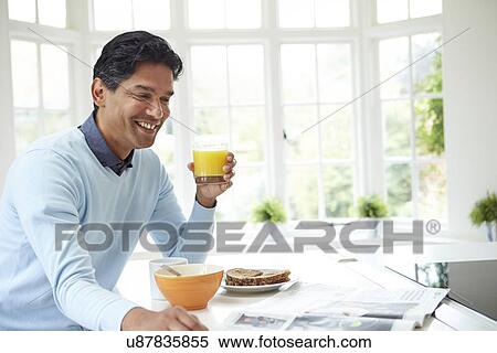 Indian Man Enjoying Breakfast At Home View Large Photo Image Stock Photography - Indian Man Enjoying Breakfast At Home. Fotosearch