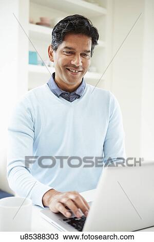 Indian Man Using Laptop At Home View Large Photo Image Stock Image - Indian Man Using Laptop At Home. Fotosearch
