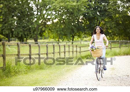 Indian Woman On Cycle Ride In Countryside View Large Photo Image Stock Photo - Indian Woman On Cycle Ride In Countryside. Fotosearch