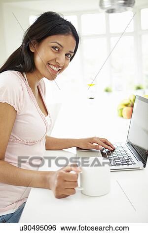 Indian Woman Using Laptop At Home View Large Photo Image Stock Photograph - Indian Woman Using Laptop At Home. Fotosearch