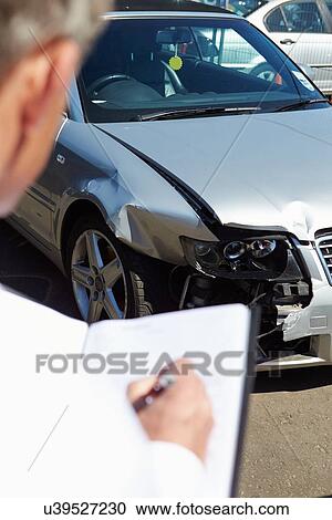 Stock Image - Loss Adjuster Inspecting Car Involved In Accident. Fotosearch