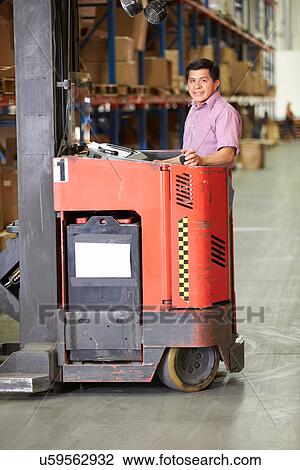 Man Driving Fork Lift Truck In Warehouse View Large Photo Image Stock Image - Man Driving Fork Lift Truck In Warehouse. Fotosearch