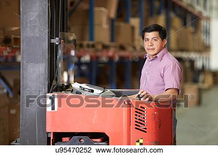 Man Driving Fork Lift Truck In Warehouse View Large Photo Image Stock Image - Man Driving Fork Lift Truck In Warehouse. Fotosearch