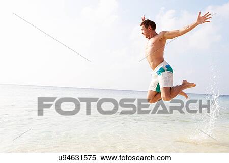 Man Jumping In The Air On Tropical Beach View Large Photo Image Stock Photography - Man Jumping In The Air On Tropical Beach. Fotosearch