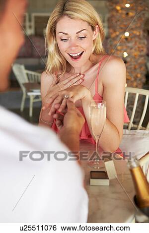 Stock Photograph - Man Proposing To Woman In Restaurant. Fotosearch