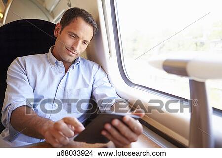 Man Reading E Book On Train View Large Photo Image Picture - Man Reading E Book On Train. Fotosearch