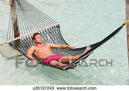 Man Relaxing In Beach Hammock View Large Photo Image Stock Image - Man Relaxing In Beach Hammock . Fotosearch
