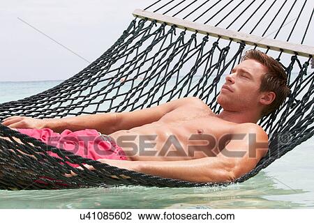 Man Relaxing In Beach Hammock View Large Photo Image Stock Image - Man Relaxing In Beach Hammock . Fotosearch