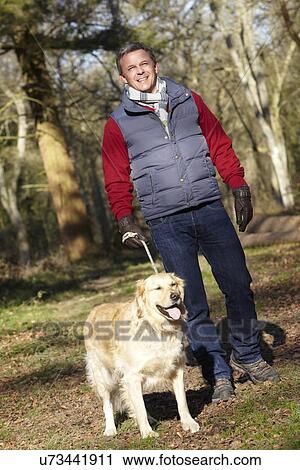 Man Taking Dog On Walk Through Autumn Woods View Large Photo Image Stock Image - Man Taking Dog On Walk Through Autumn Woods. Fotosearch